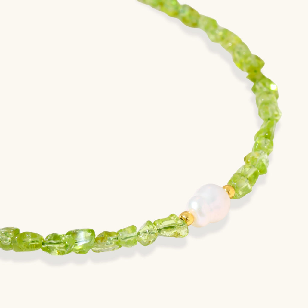 Delicate sterling silver bracelet with lime-green peridot gemstone chips and single freshwater pearl centerpiece