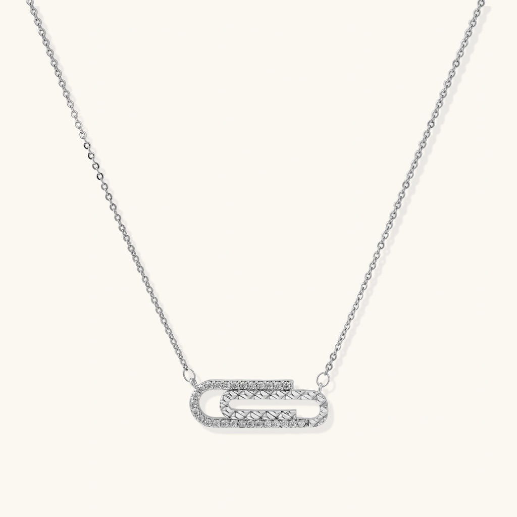 White gold plated necklace with dual-frame geometric pendant featuring crystal pavé border on pale background.