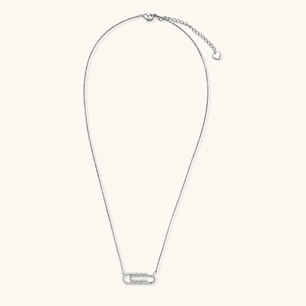 White gold plated necklace with dual-frame geometric pendant featuring crystal pavé border on pale background.