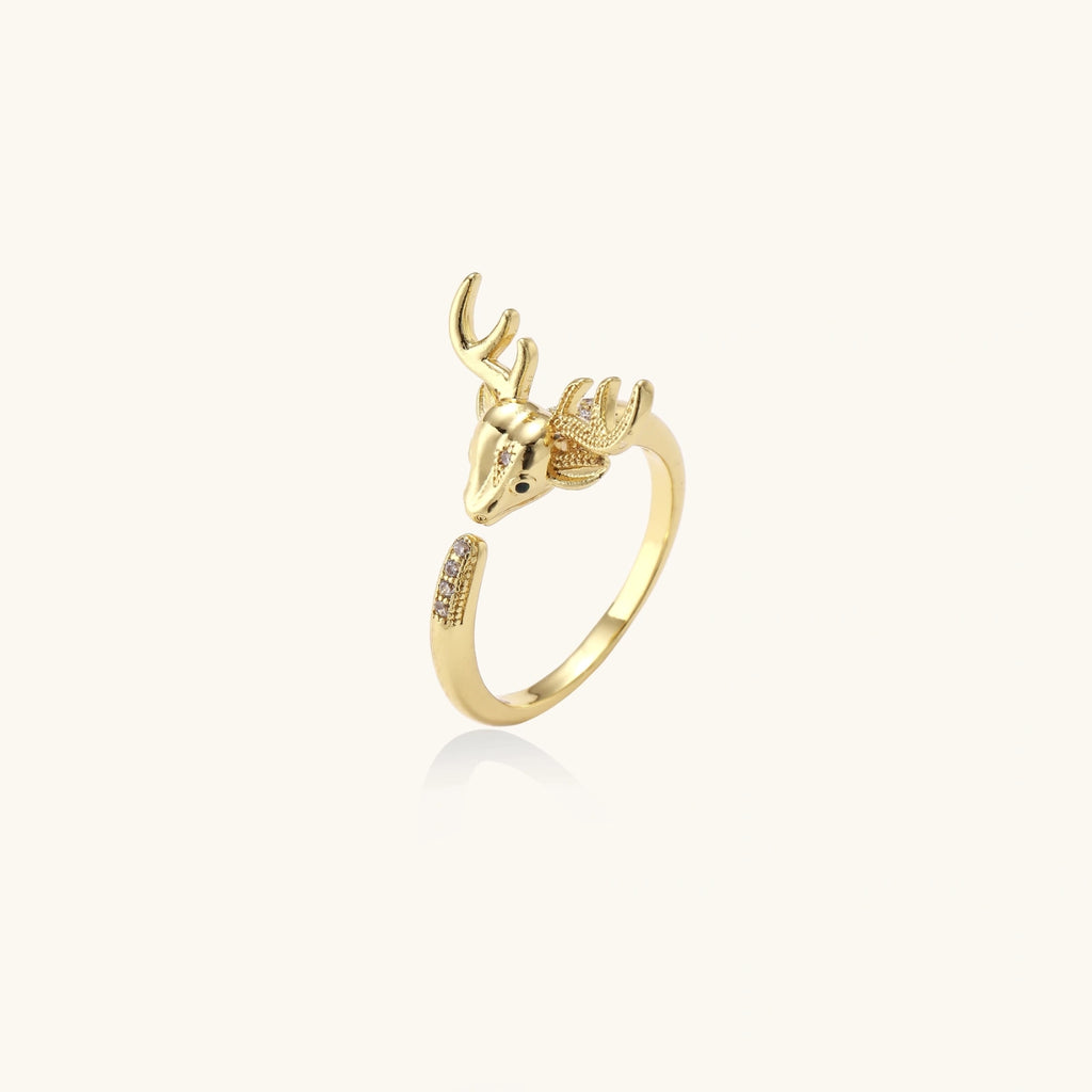 Gold-plated adjustable ring featuring 3D deer head with detailed antlers and cubic zirconia accents on cream background