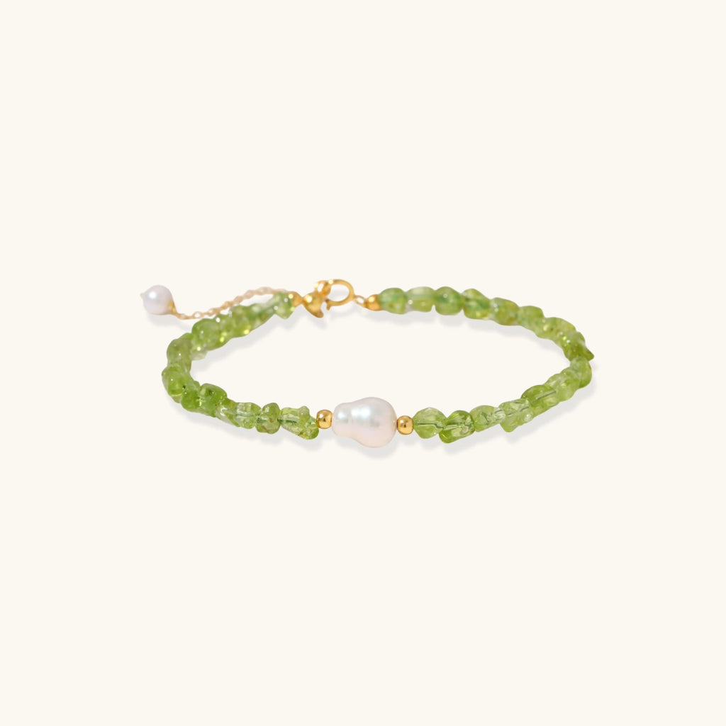 Delicate sterling silver bracelet with lime-green peridot gemstone chips and single freshwater pearl centerpiece