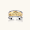 Wide two-tone ring with gold center band featuring intricate patterns and crystal accents on silver borders